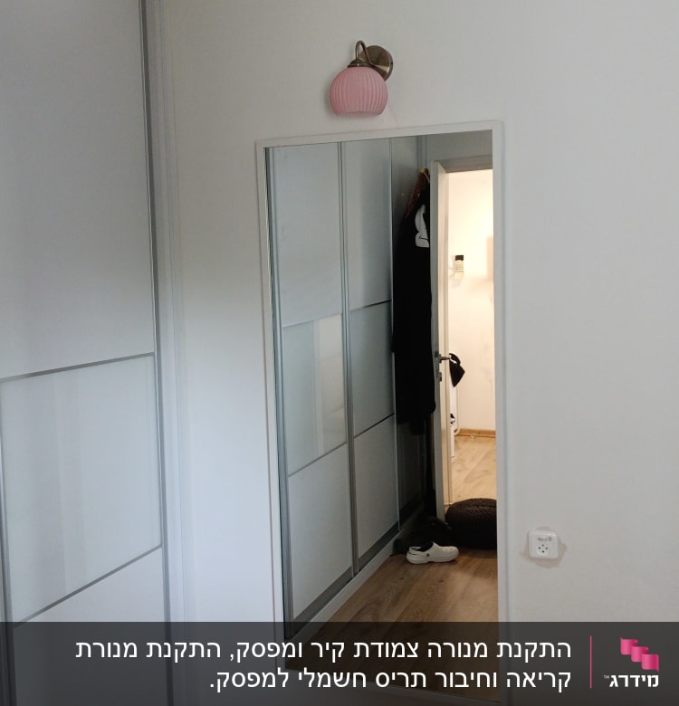 שקע חשמל על קיר לבן בחדר שינה